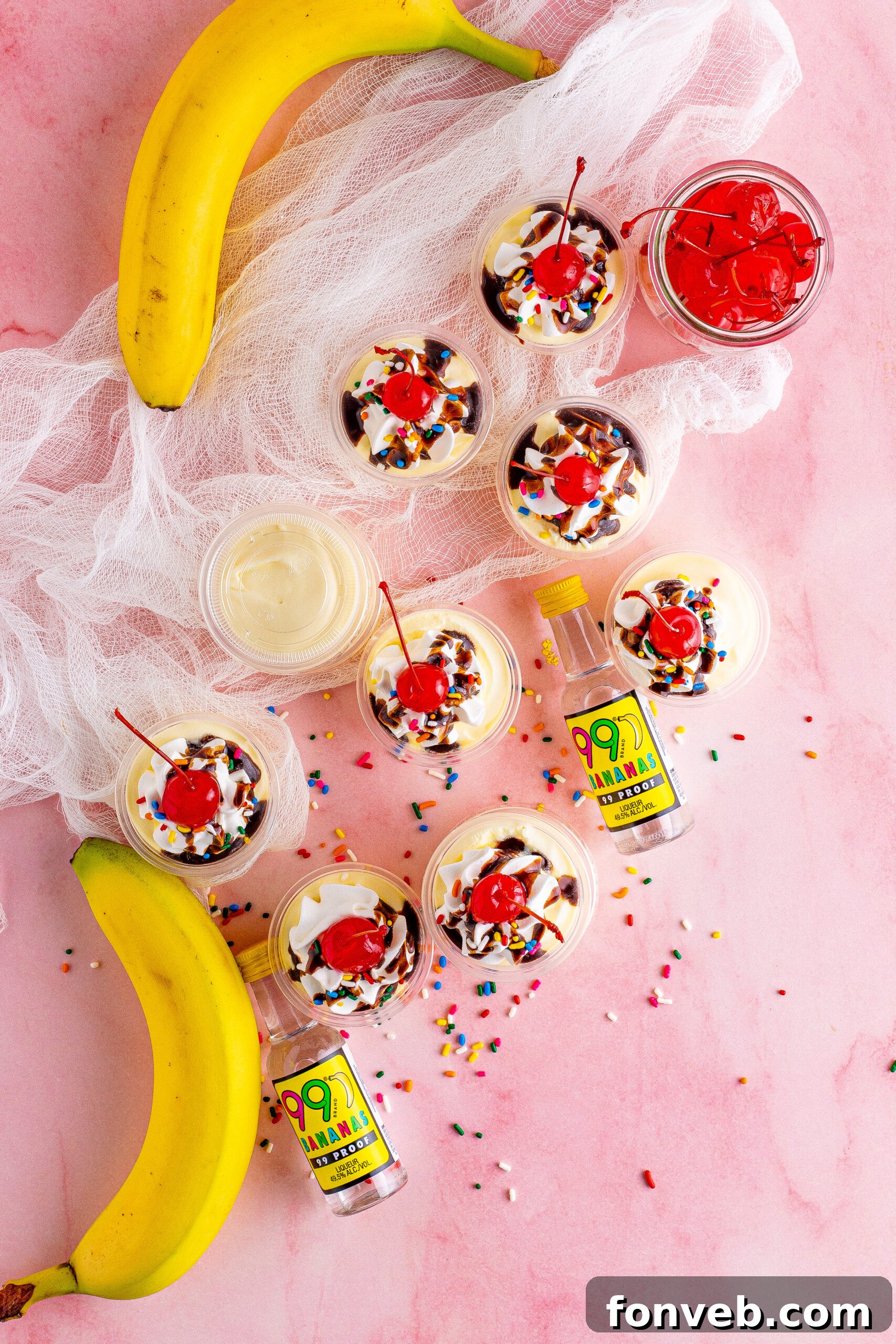 Mini Banana Split Delights 3 Overhead view of Banana Split Shots arranged artfully, adorned with rainbow sprinkles and cherries.