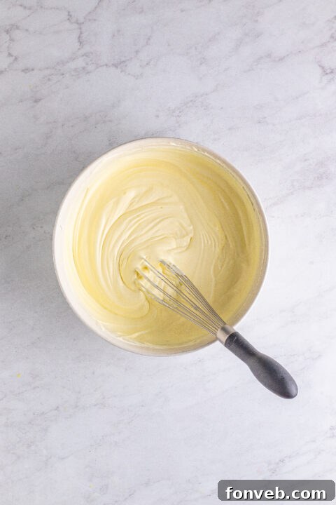 Mini Banana Split Delights 10 A row of Banana Split Shots topped with whipped cream and cherries.