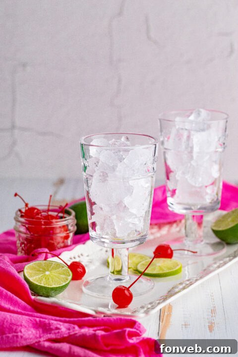 Close up of a Dirty Shirley Temple on a reflective surface.