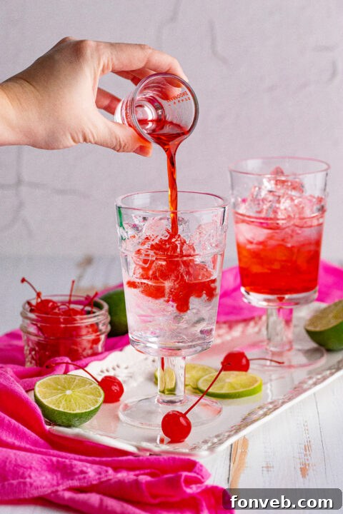 Two Dirty Shirley Temples, one with a cherry, the other with a lime.