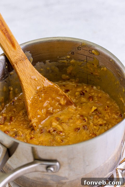 Spreading the topping over the cooled brownies.