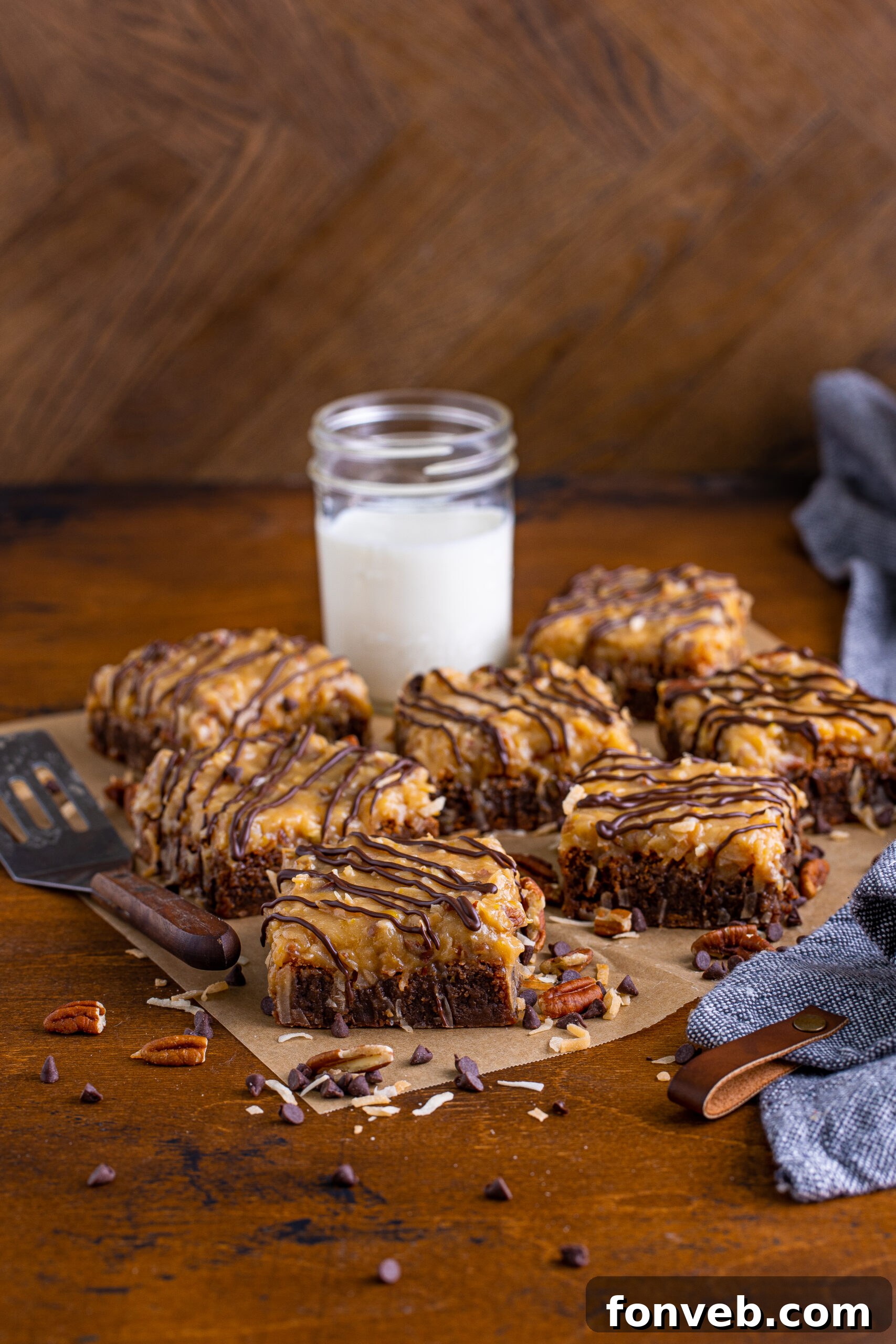 Front view of several German Chocolate Brownies on a piece of parchment paper, ready to be served.