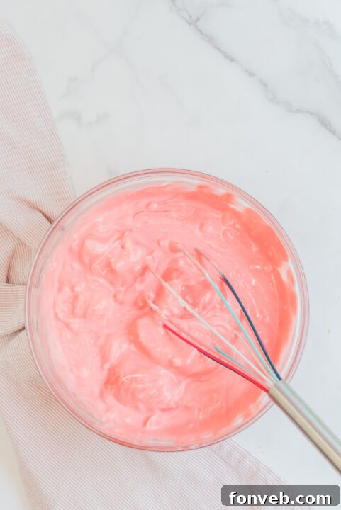 Luscious Raspberry Whip 12 Raspberry Jello Fluff mixture being gently folded.