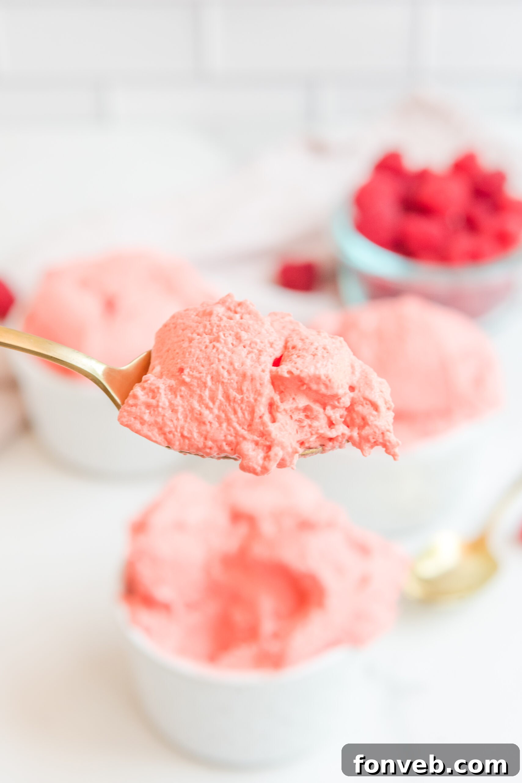 Luscious Raspberry Whip 16 Front view of a gold spoon with a generous spoonful of Raspberry Jello Fluff, showing its luscious texture.