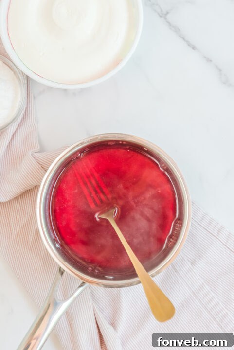 Luscious Raspberry Whip 9 Raspberry Jello Fluff in a bowl, showing its light and airy texture.