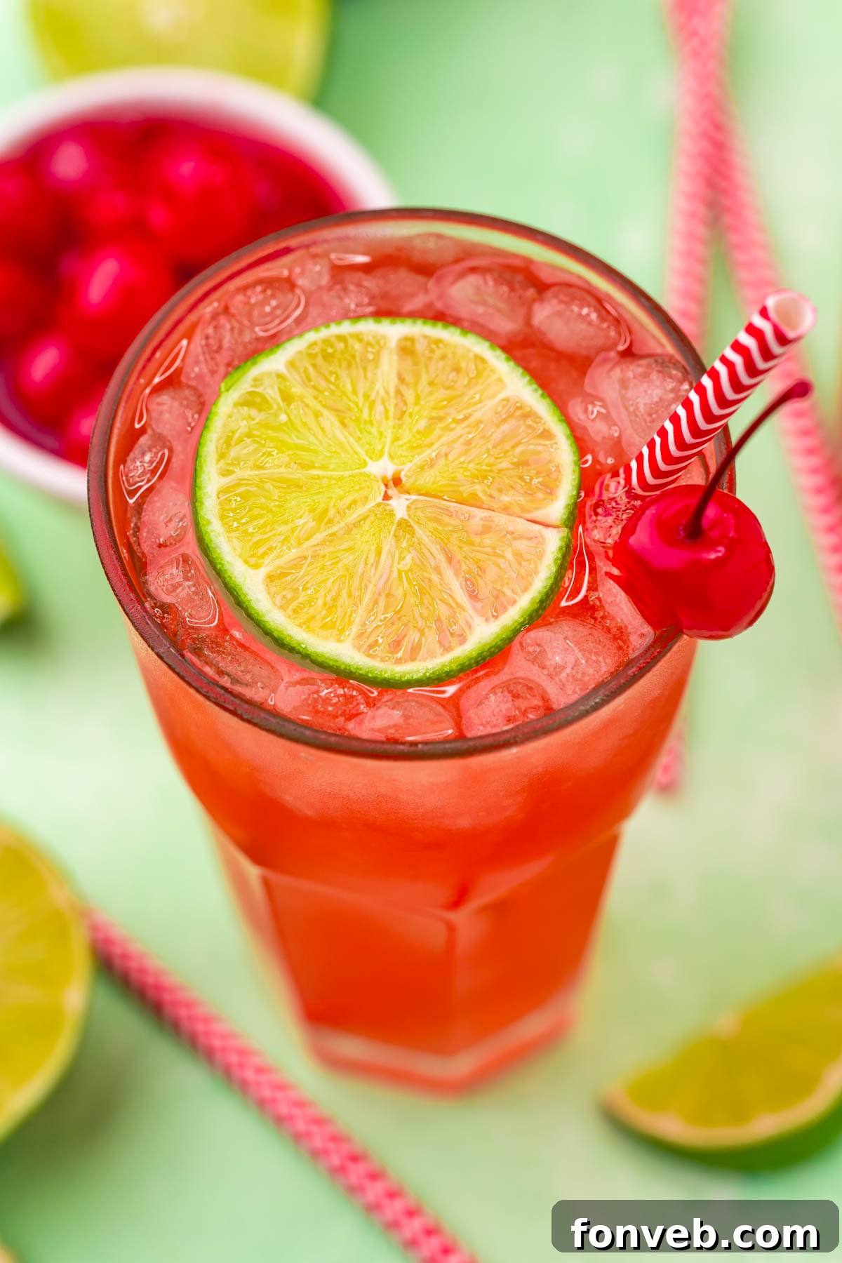 Crimson Zest Quencher 14 A refreshing glass of Cherry Limeade, garnished with a lime wedge and a cherry, symbolizing a perfect summer beverage.