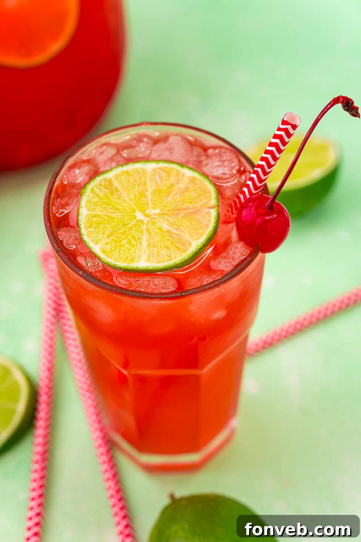 Crimson Zest Quencher 15 A close-up shot of a Cherry Limeade, expertly garnished with a lime and cherry, highlighting its refreshing qualities and vibrant colors.