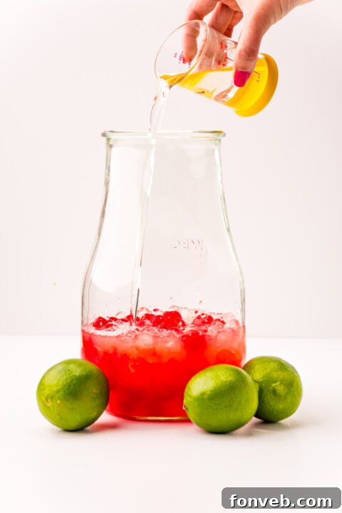 Crimson Zest Quencher 8 The process of adding lemon-lime soda to a pitcher containing other Cherry Limeade ingredients, highlighting the carbonation.