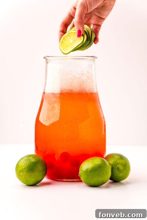 Crimson Zest Quencher 10 A close-up of the fully mixed Cherry Limeade in a pitcher, revealing its inviting pink color and readiness for serving.
