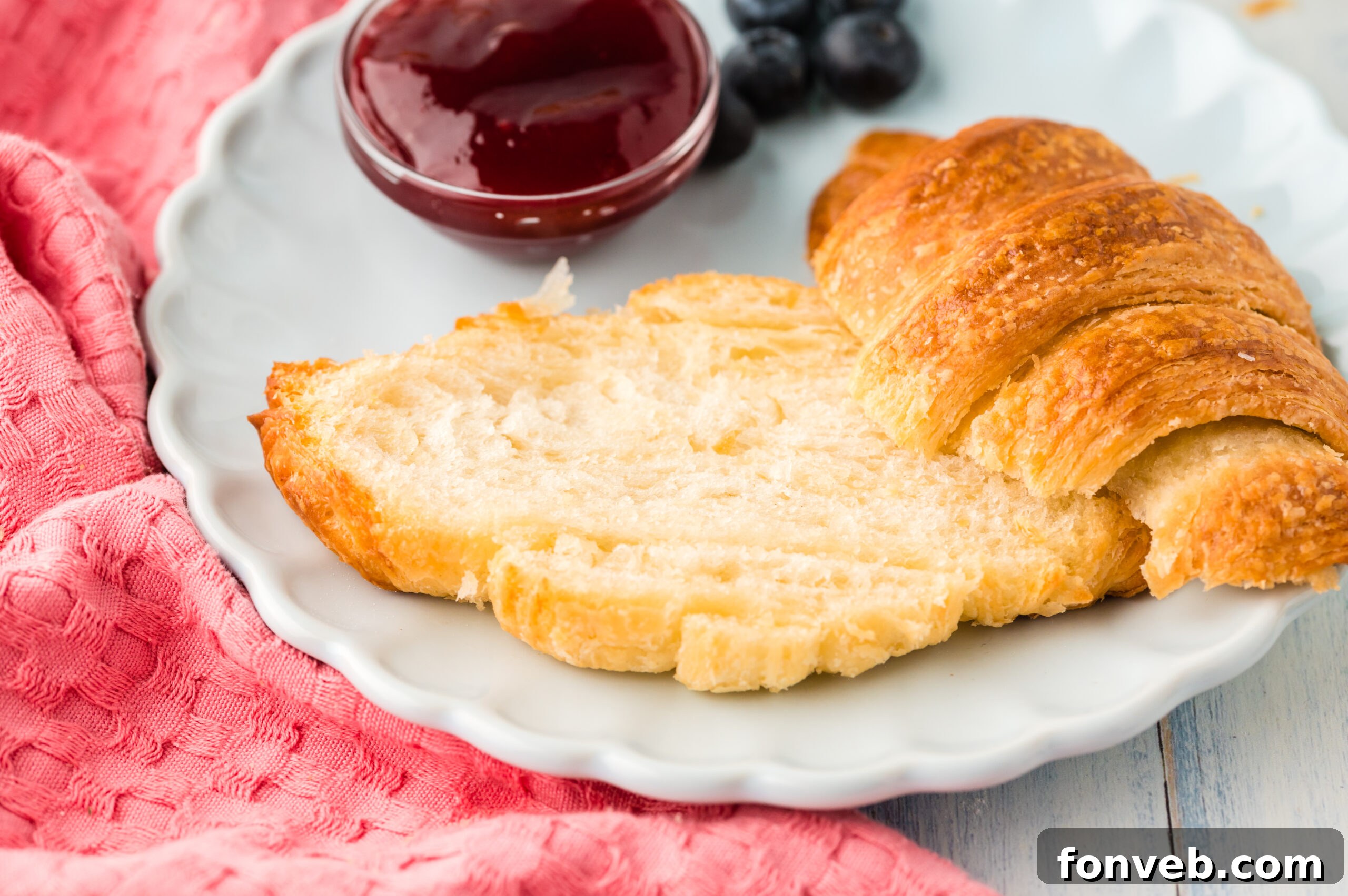 Homemade croissants sliced open to reveal their beautiful interior layers, ready to be filled or enjoyed plain.