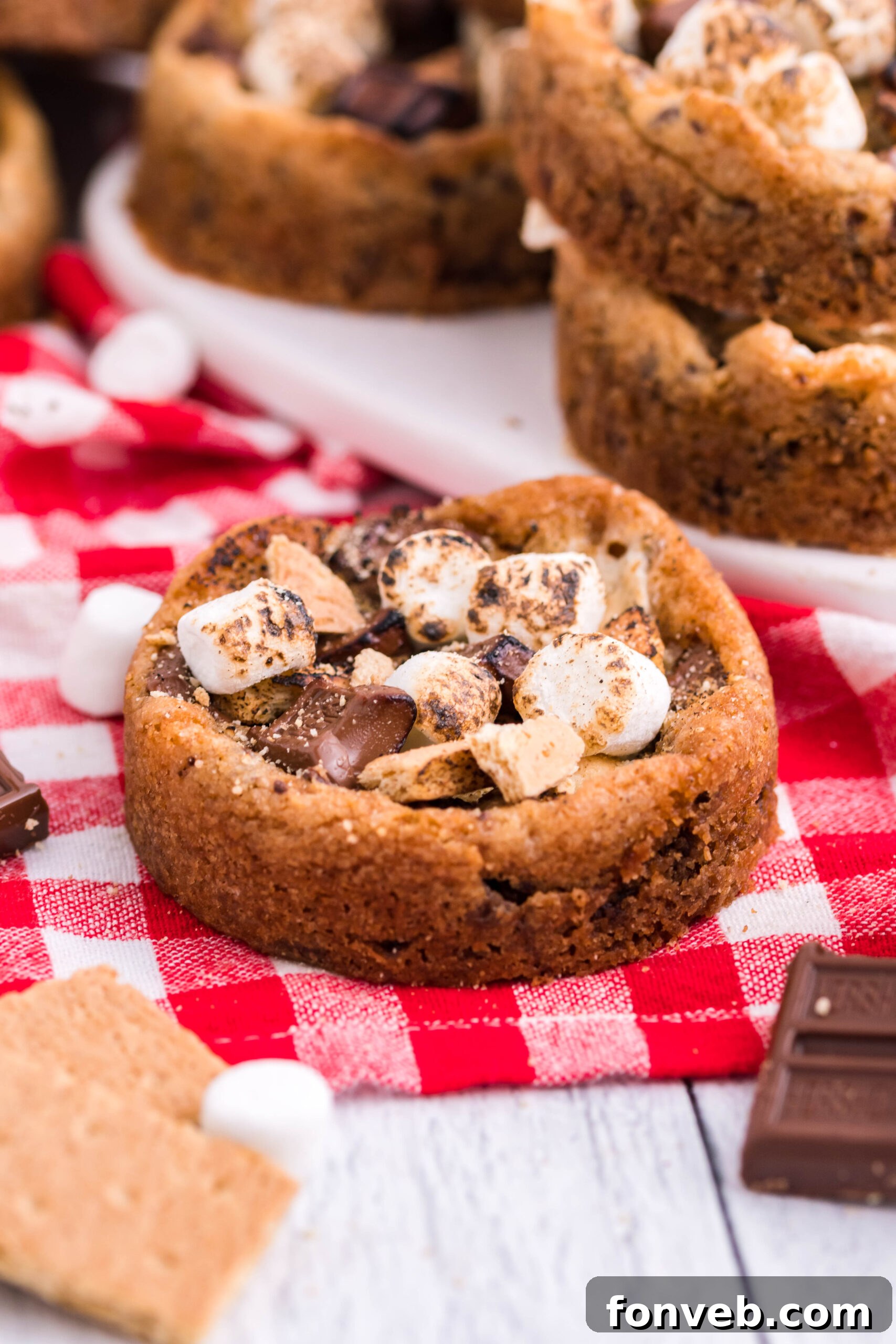 Front view of Deep Dish S’mores Cookies on red checkered linen.