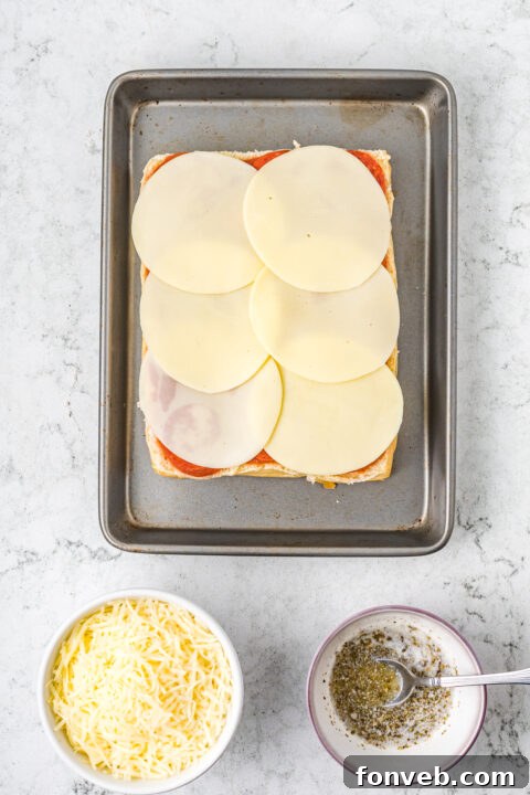 Ultimate Pizza Pull-Aparts 11 Shredded mozzarella and provolone cheese slices layered over the pizza sauce.