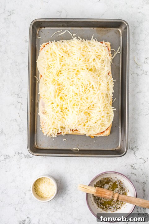 Ultimate Pizza Pull-Aparts 12 Pepperoni slices neatly placed on each roll before covering.