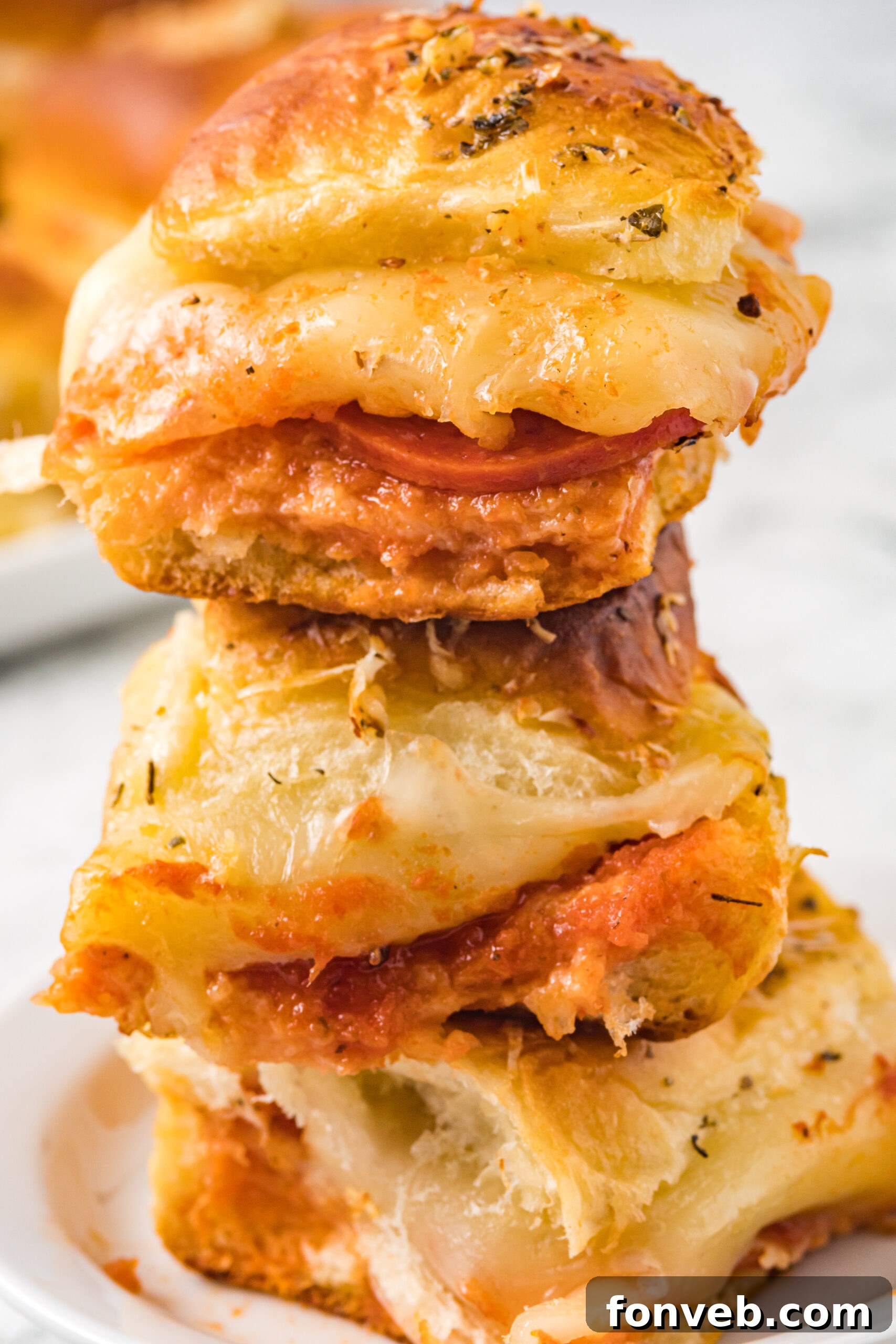 Ultimate Pizza Pull-Aparts 4 A tray of freshly baked pepperoni pizza sliders, golden brown and bubbly.