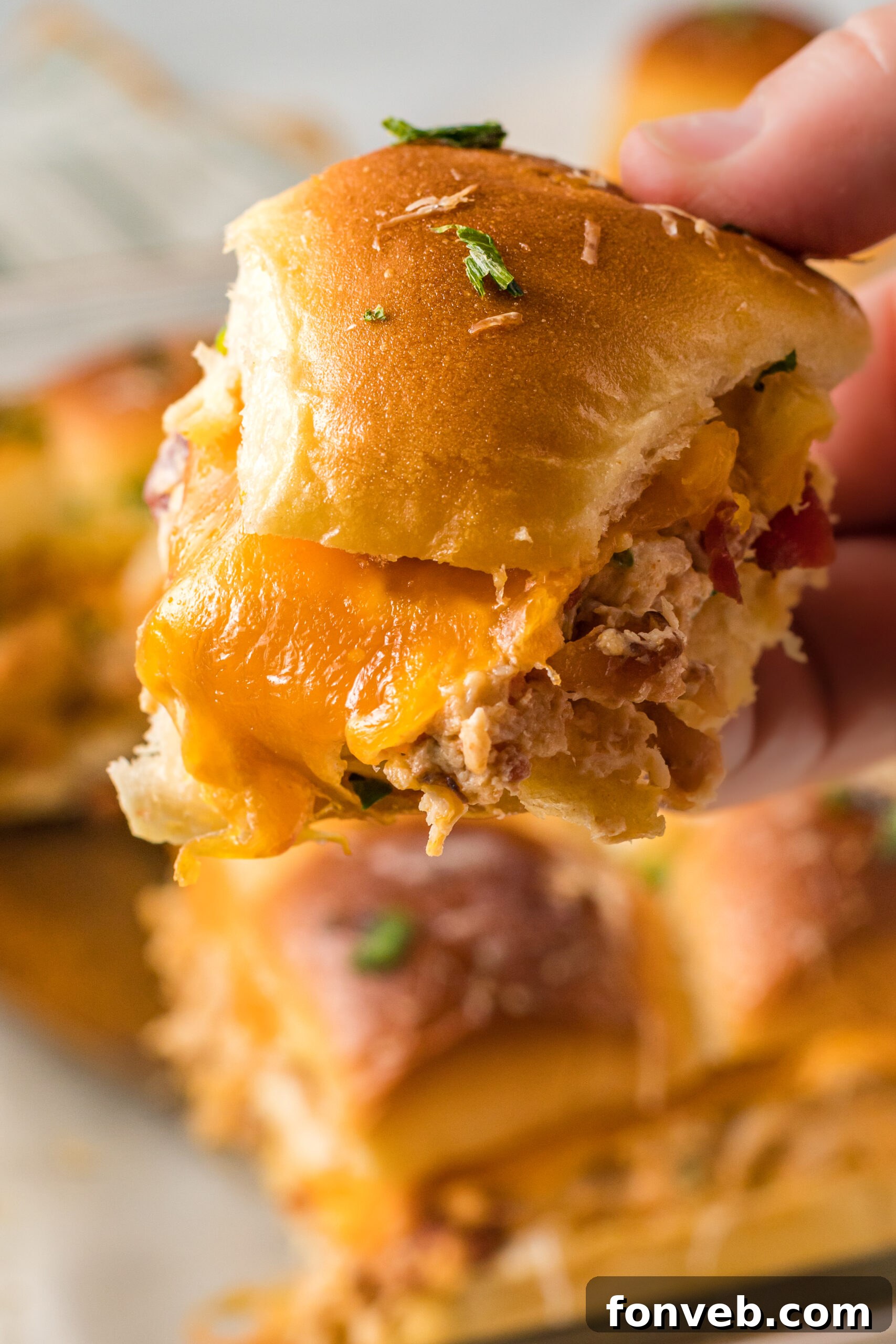 Up close view of Crack Chicken Sliders being held.