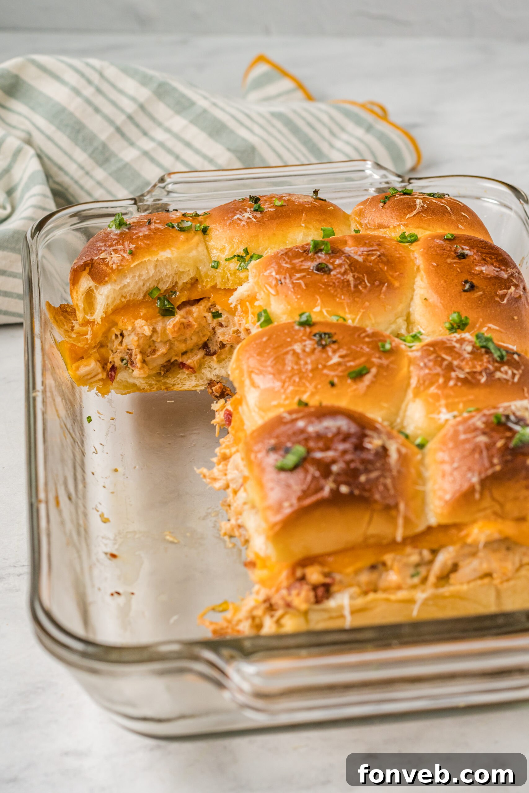 Front view of Crack Chicken Sliders in a clear baking dish.