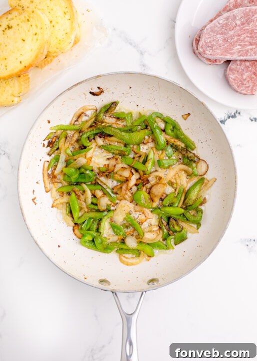 Golden Air Fryer Philly Cheesesteaks 7 Close-up of sautéed bell peppers and onions in a pan.