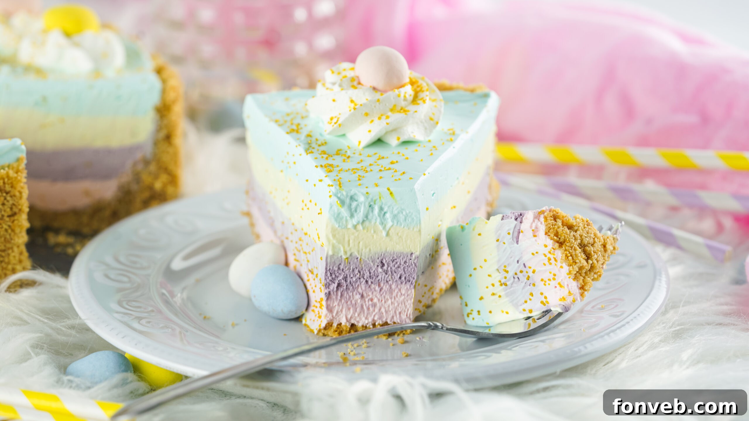 Zesty Easter Kool-Aid Pie 14 Close-up overhead view of a slice of Easter Kool Aid Pie with a small bite removed, showing its creamy texture and vibrant layers.