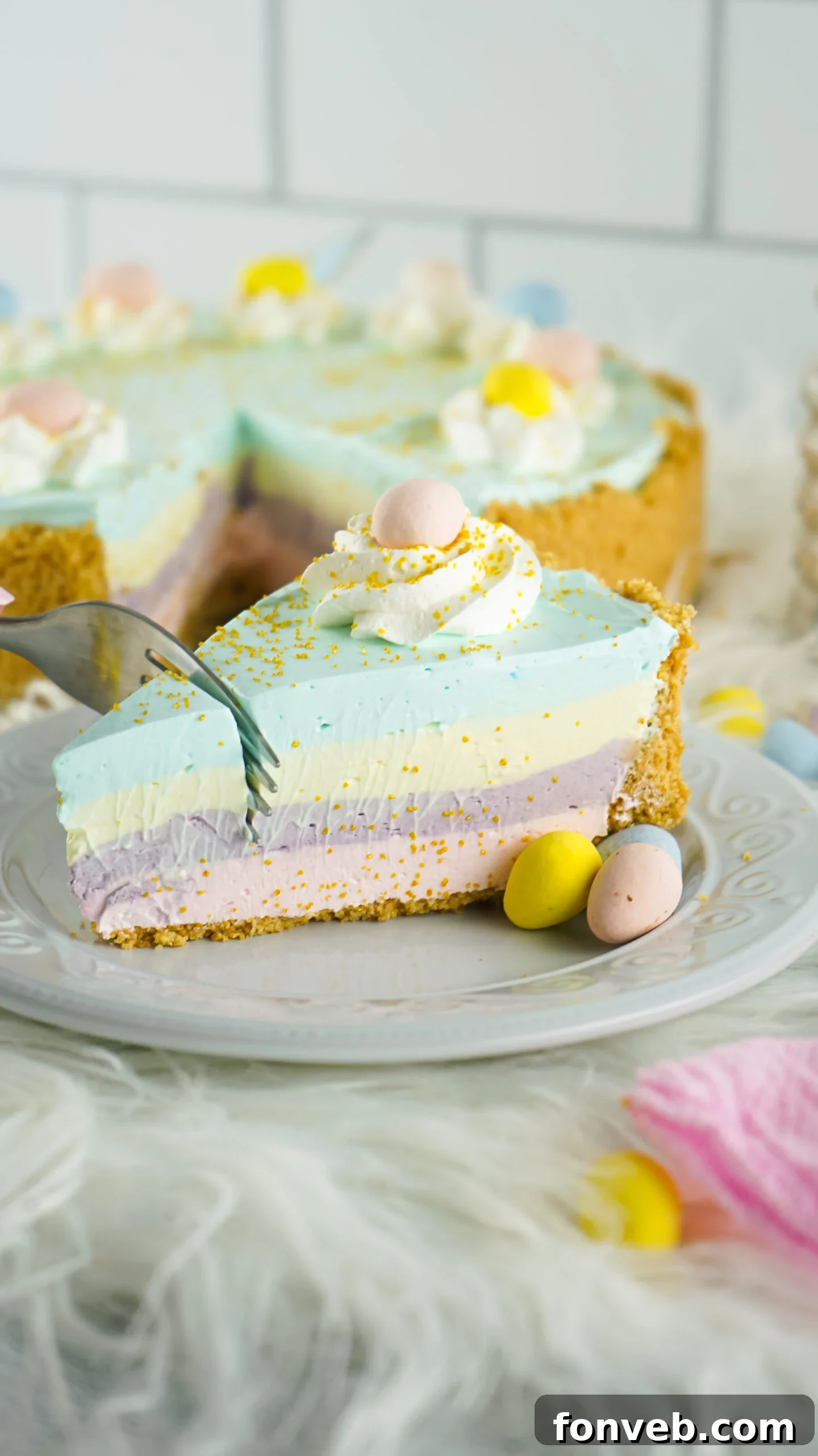 Zesty Easter Kool-Aid Pie 16 Side view of a vibrant slice of Easter Kool Aid Pie with a silver fork gently removing a bite, highlighting the creamy texture.