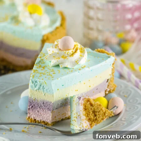 A vibrant and colorful Easter Kool Aid Pie with distinct layers, ready to be served.