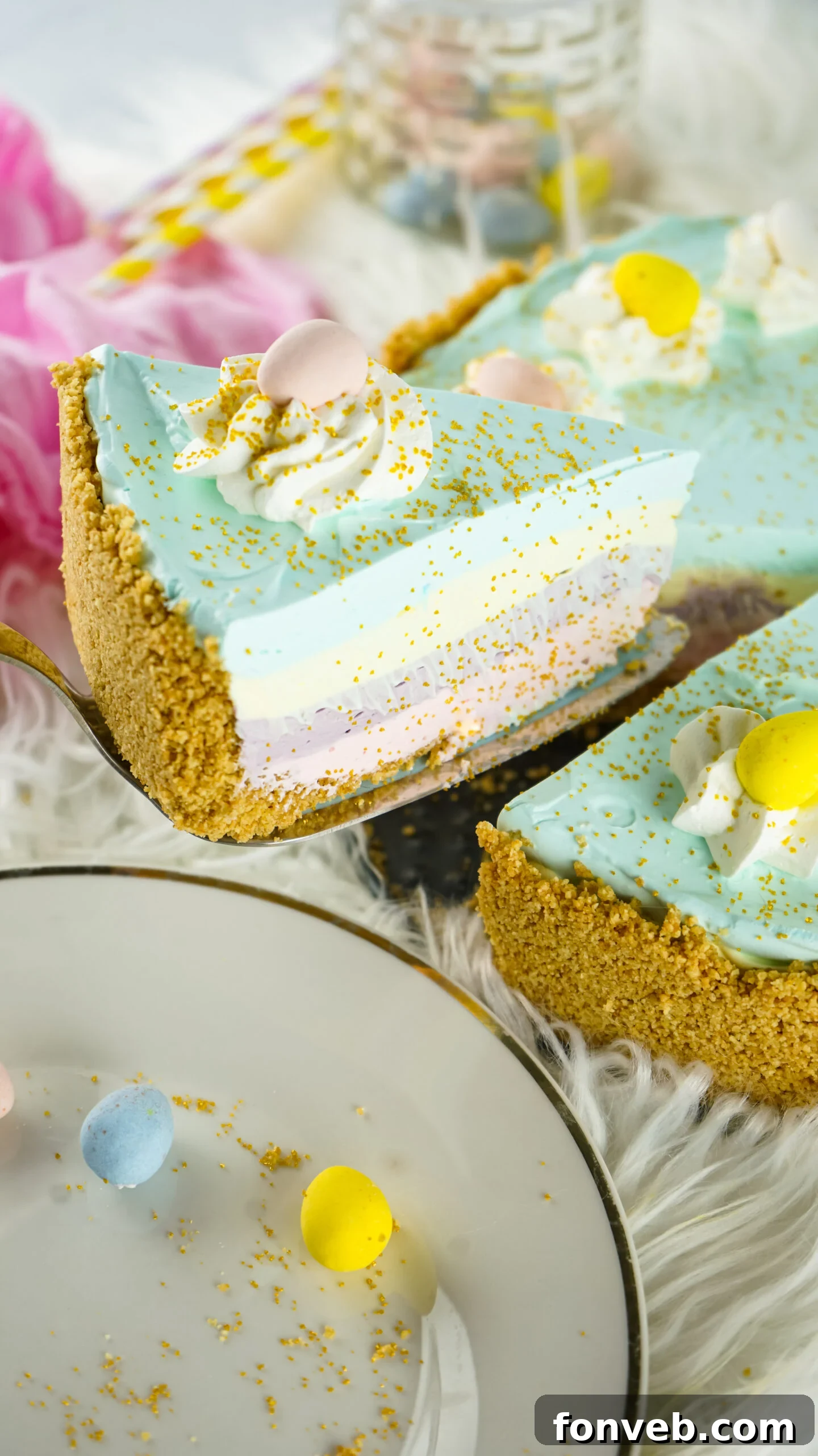 Zesty Easter Kool-Aid Pie 3 Close-up side view of a vibrant slice of Easter Kool Aid Pie on a gold cake server, highlighting its smooth texture and colorful layers.