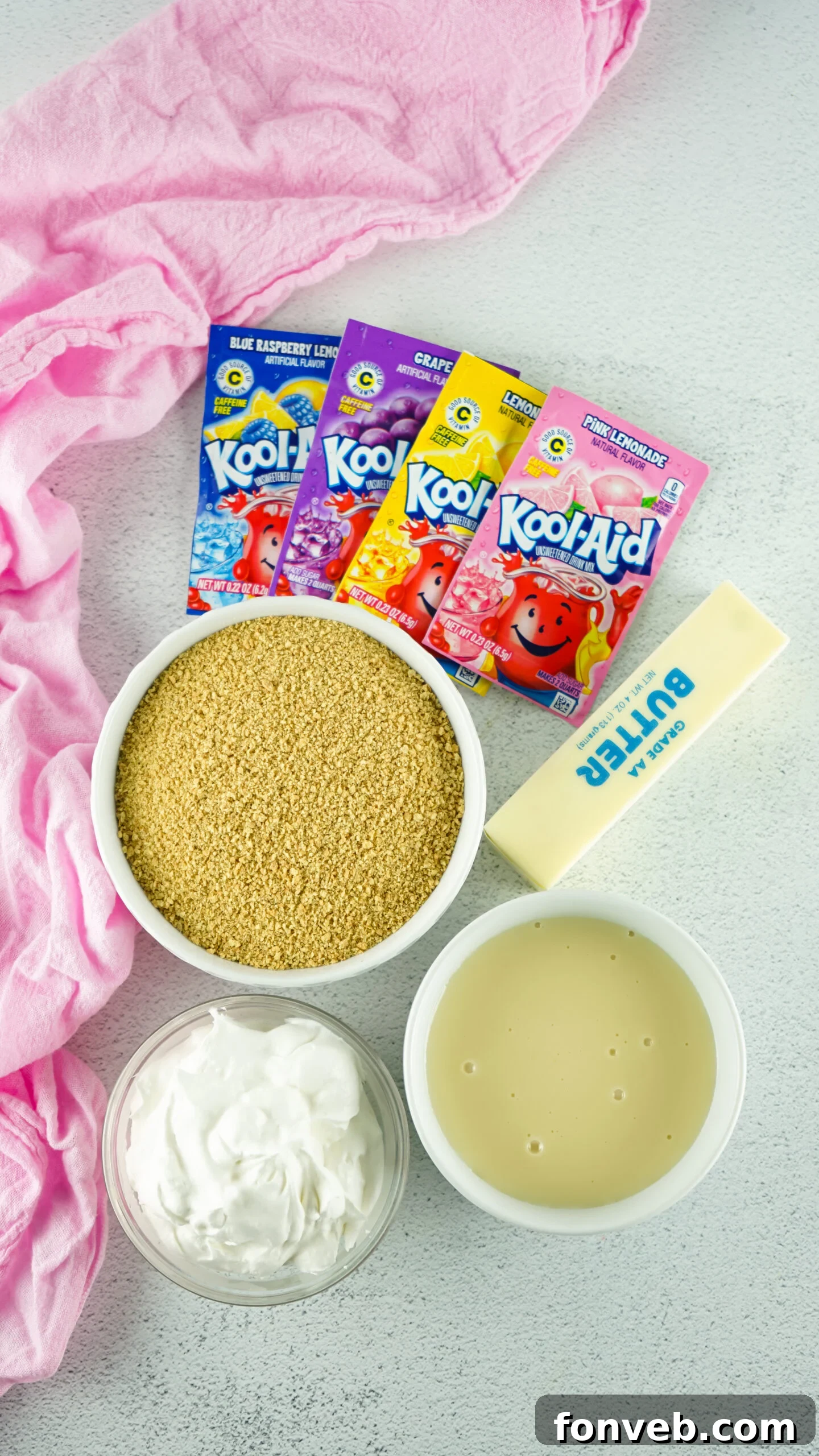 Zesty Easter Kool-Aid Pie 7 Overhead view of all the raw ingredients neatly laid out on a surface, ready for preparing the Easter Kool Aid Pie.