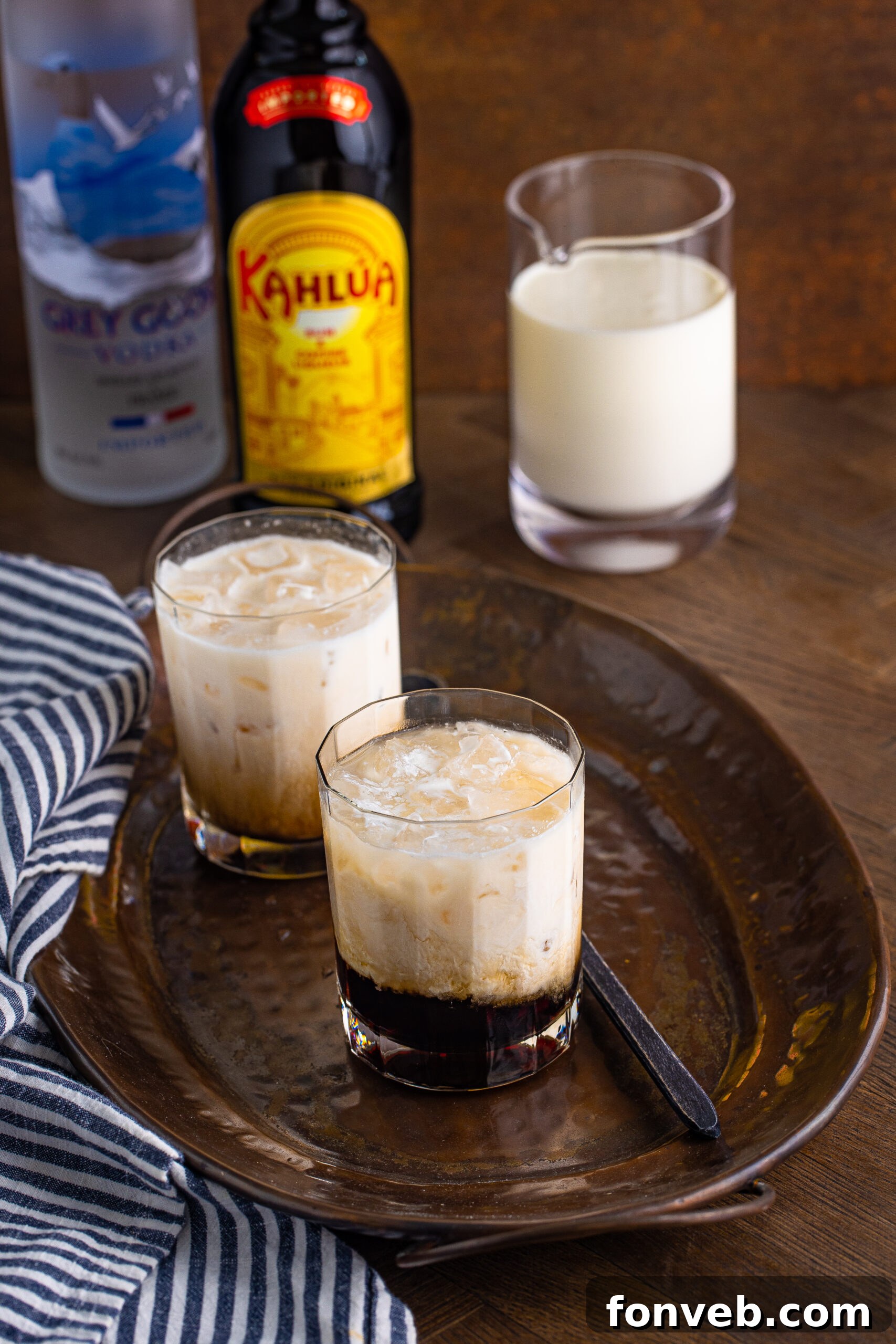 The Dude's Favorite Drink 12 A White Russian in a clear glass, with a soft focus on the drink and a dark background.