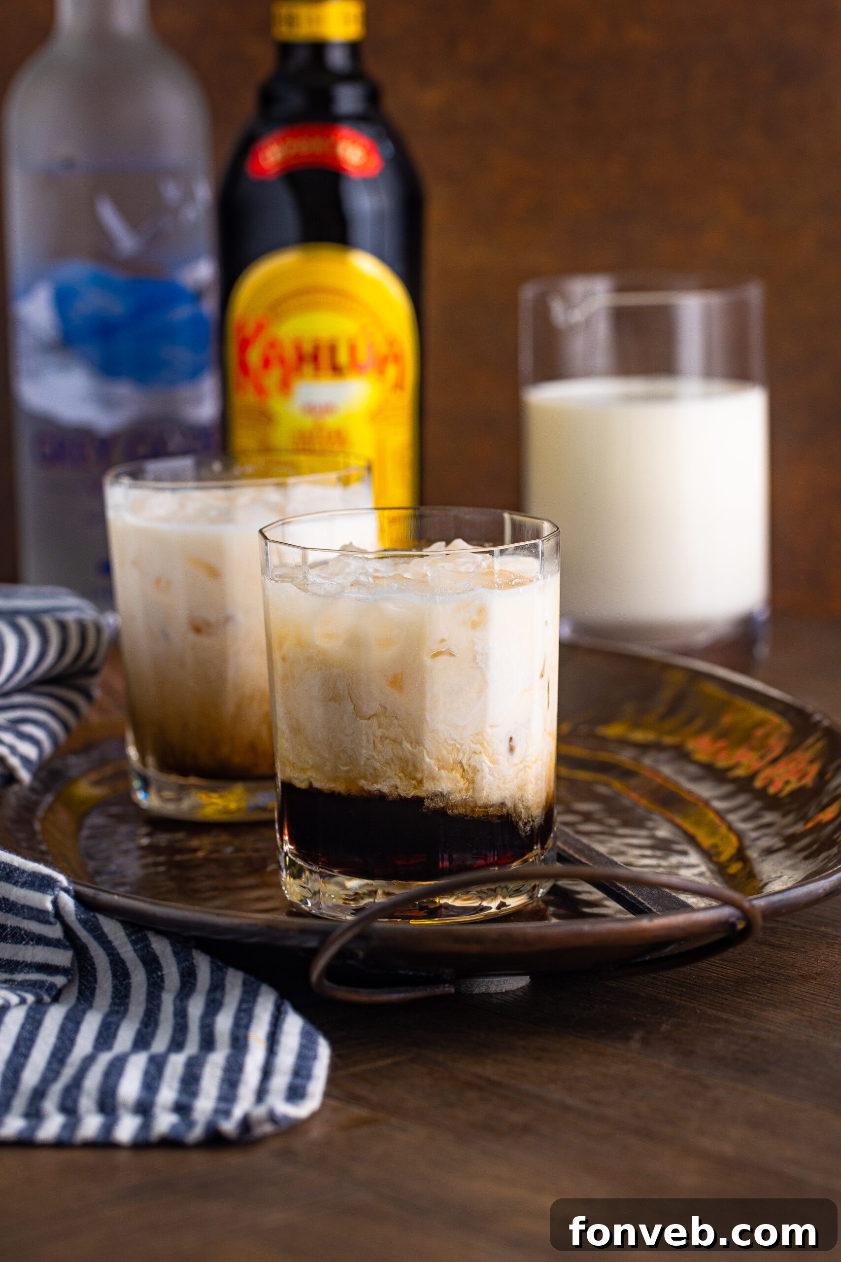 The Dude's Favorite Drink 6 Another view of a White Russian in a clear glass, invitingly presented on a dark metal serving tray.