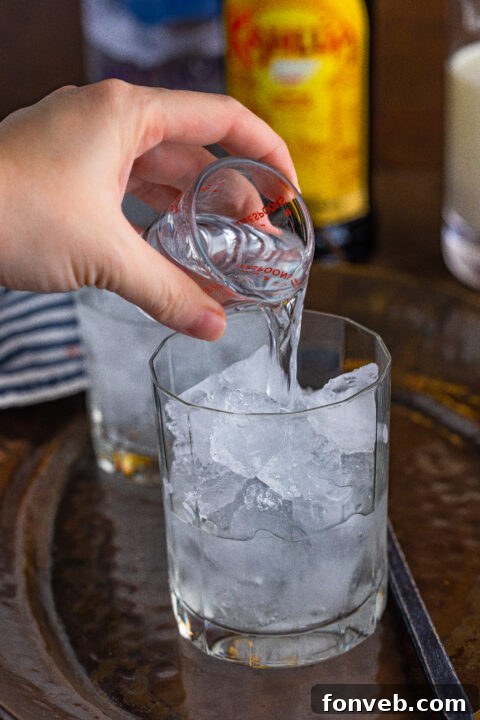 The Dude's Favorite Drink 8 Three White Russian cocktails in glasses, showing variations in mixing or presentation, on a dark surface.