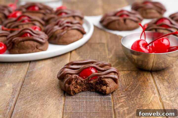 Chocolate Cherry Cookie on a wooden table with the front one missing a bite