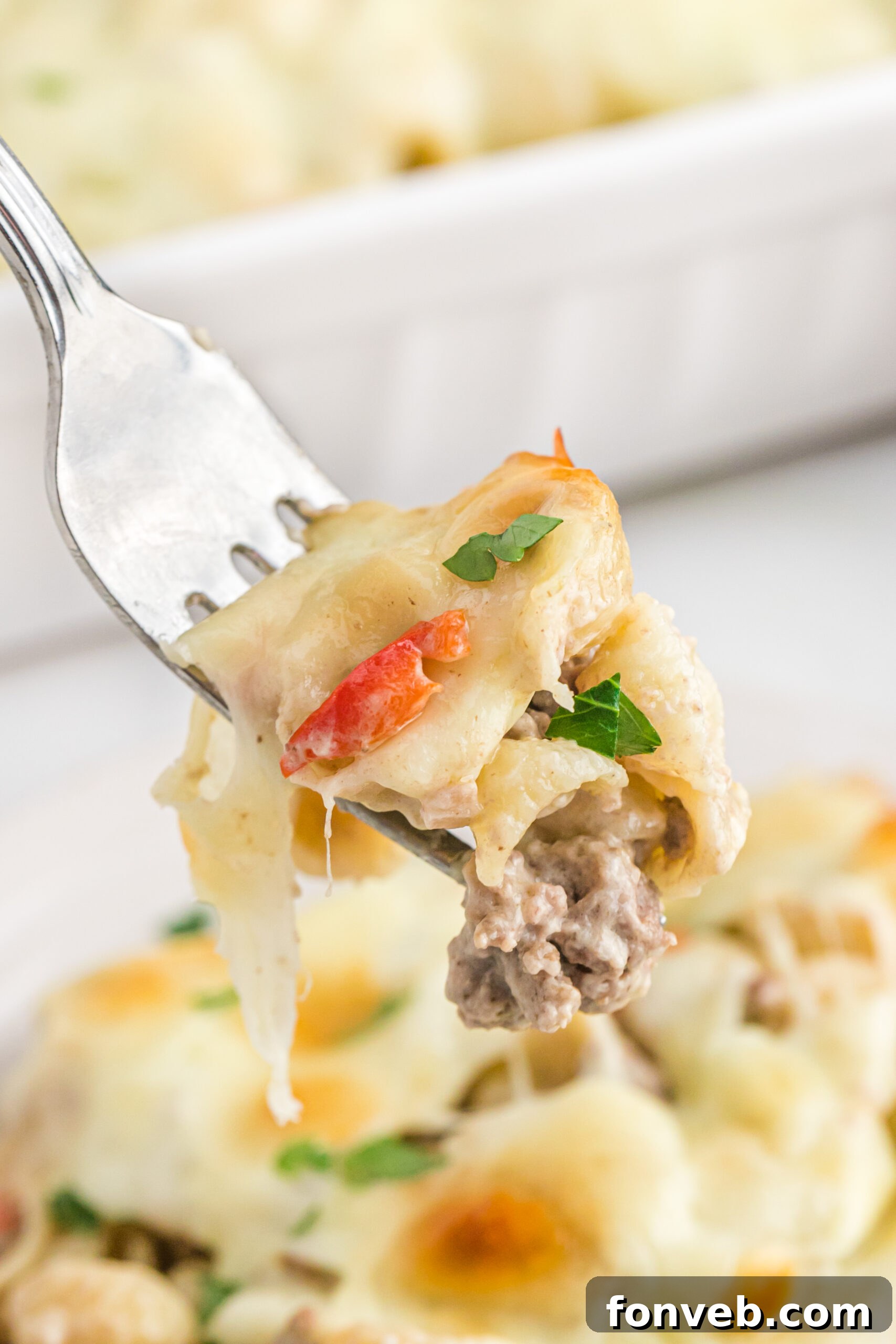 Up close view of Philly Cheesesteak Casserole on a silver fork.