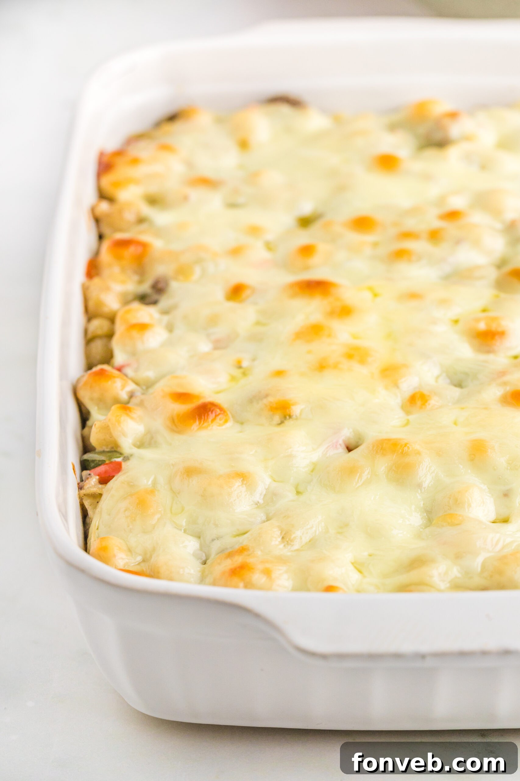 Up close view of Philly Cheesesteak Casserole in a white baking dish.