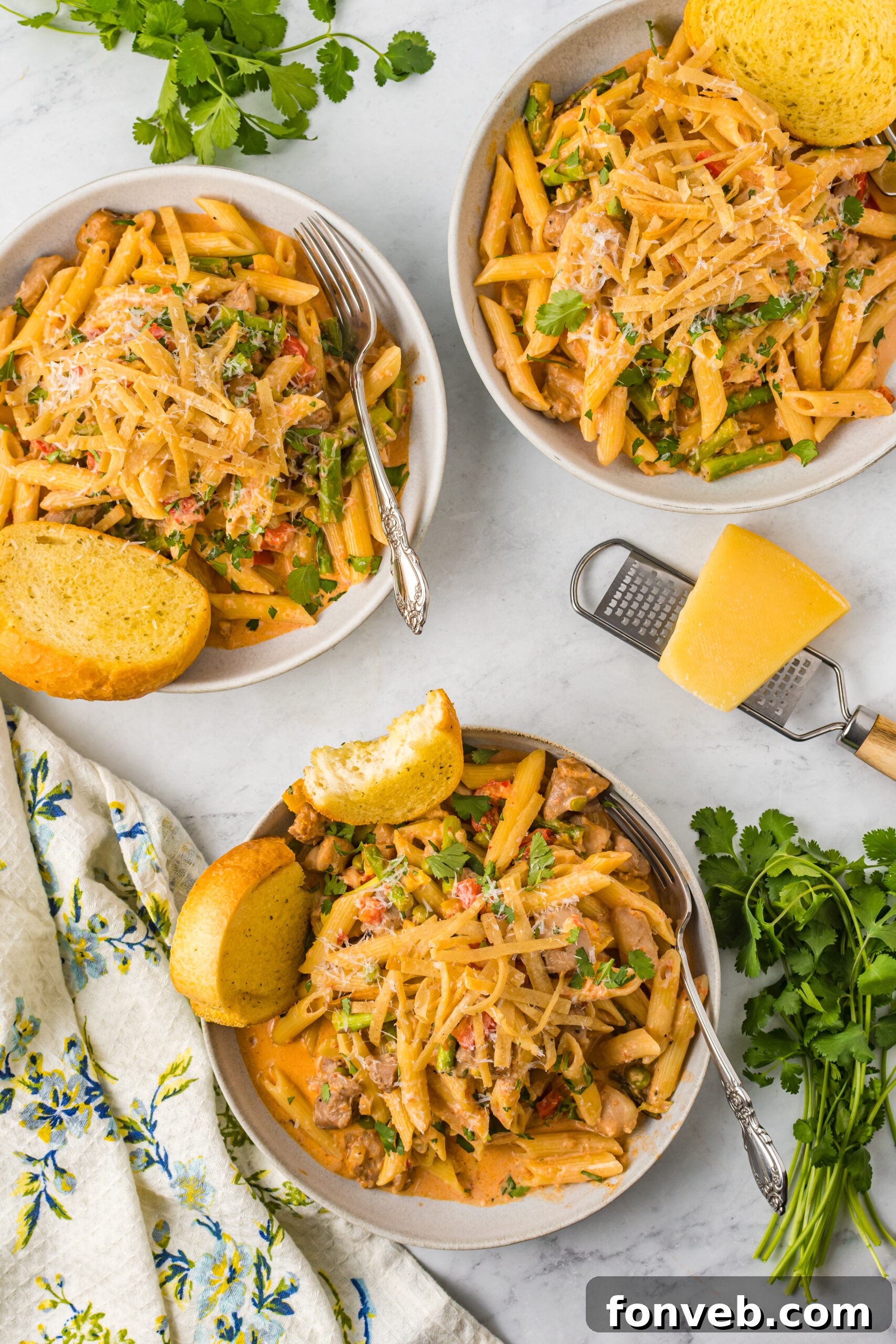 Overhead shot of a beautifully served dish of Cajun Chicken Pasta with garlic bread, ready for a satisfying meal.