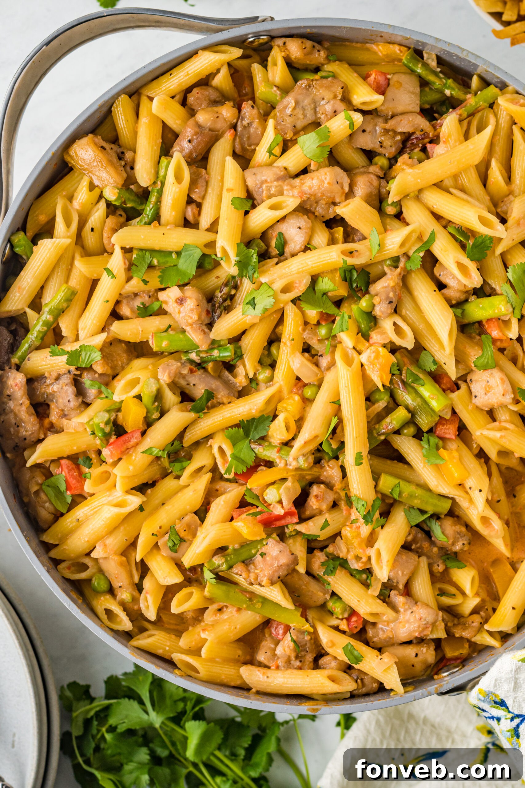 Overhead view of Creamy Cajun Chicken Pasta simmering in a large skillet, showcasing its rich sauce and tender ingredients.