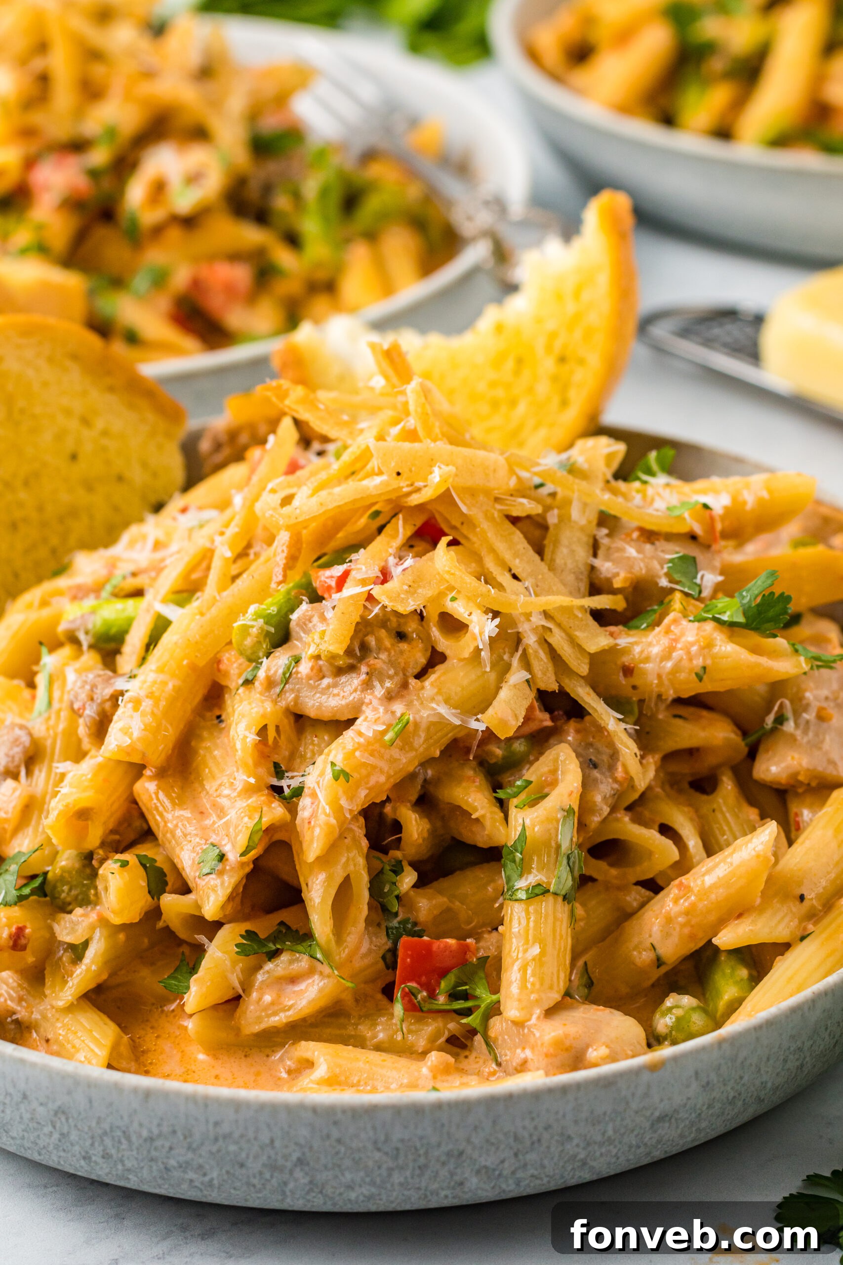 A detailed close-up of Cajun Chicken Pasta, showcasing the perfectly coated penne, succulent chicken, and colorful vegetables.