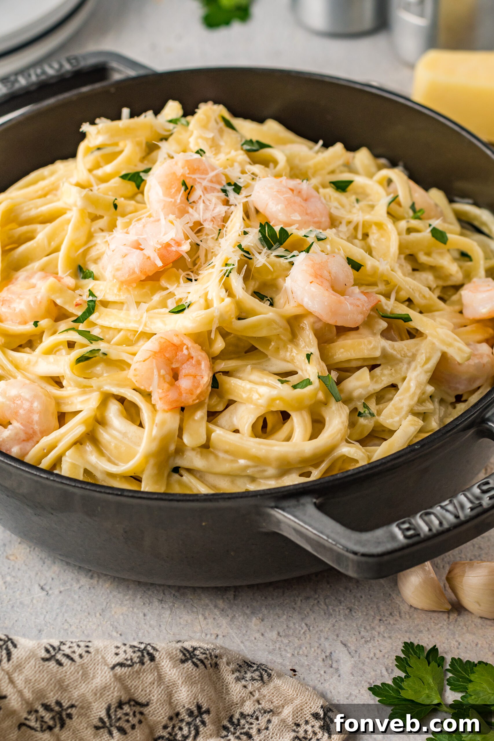 Front view of Shrimp Alfredo in a black cast iron pot.