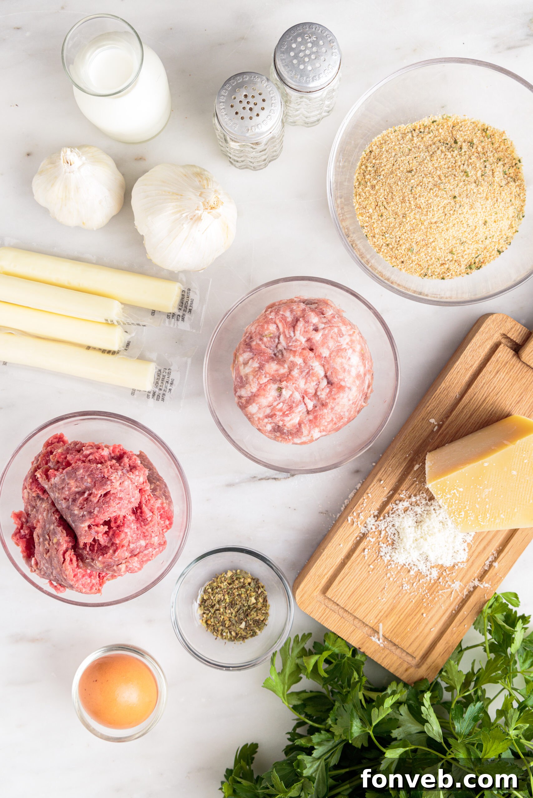 Overhead view of all the fresh ingredients laid out on a table, ready for the Mozzarella Stuffed Meatballs recipe.