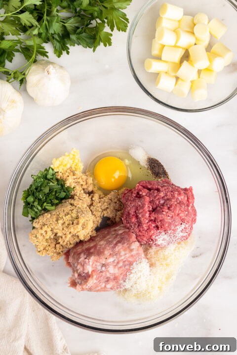 Close-up of raw meatball mixture being pressed to form the base for stuffing.