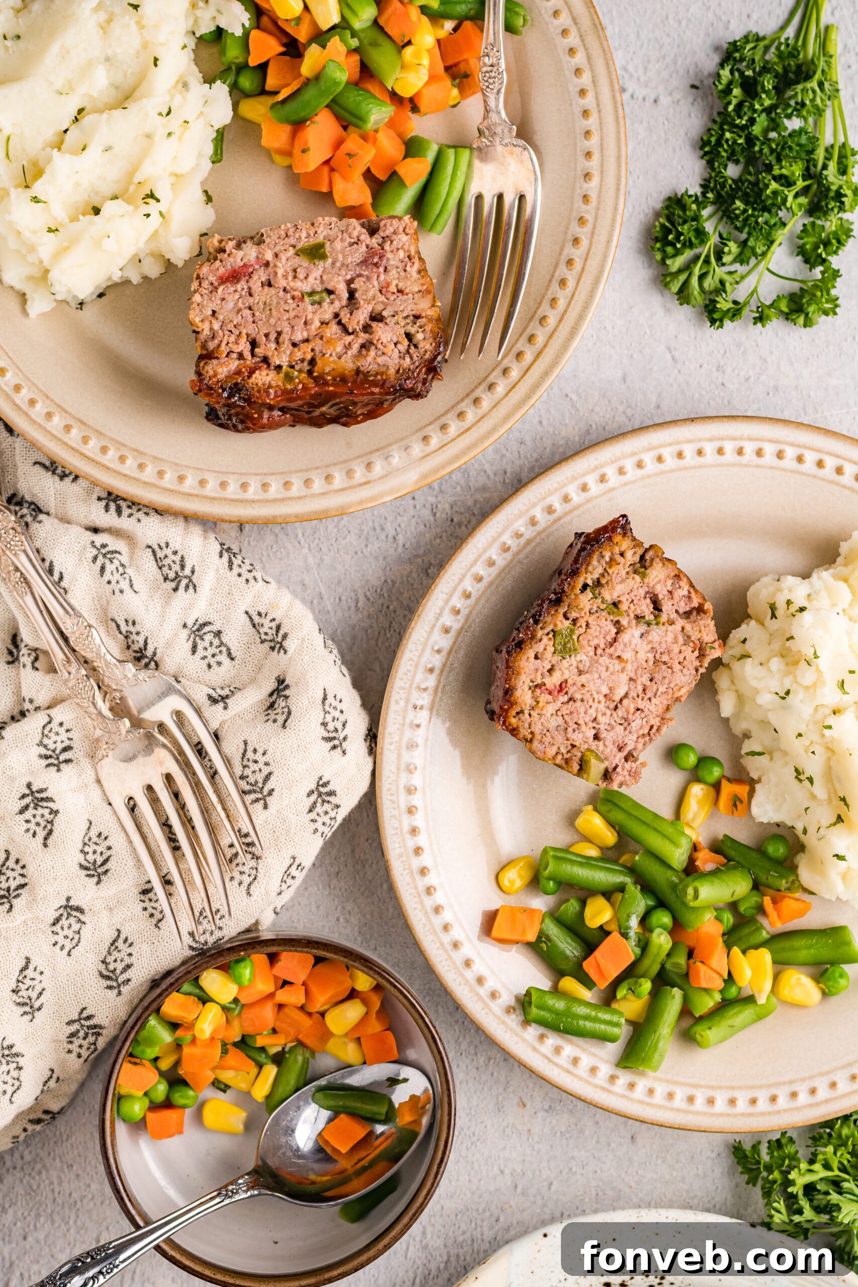 Overhead view of Cracker Barrel Meatloaf slices served with mashed potatoes and mixed vegetables.