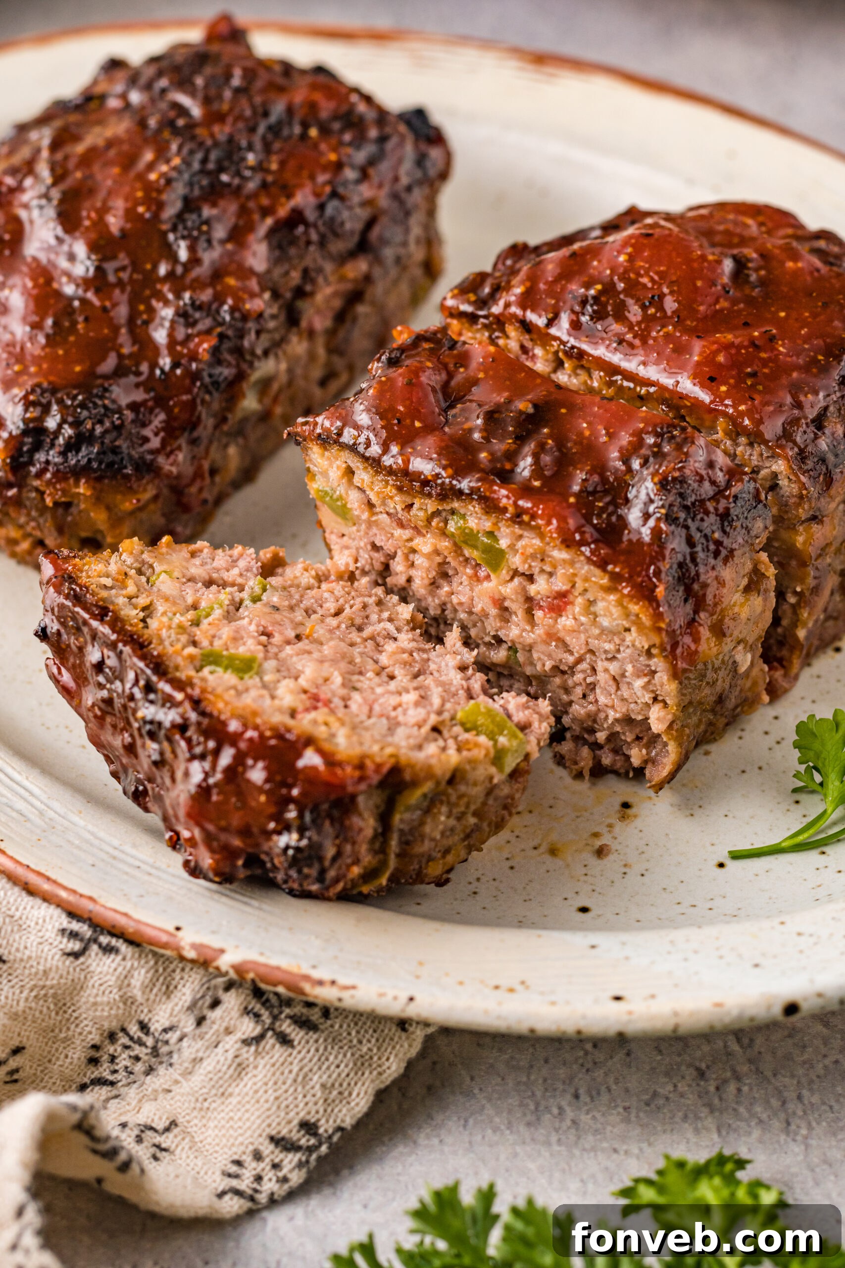 Front view of Cracker Barrel Meatloaf on a serving dishes with slices cut from the meatloaf.