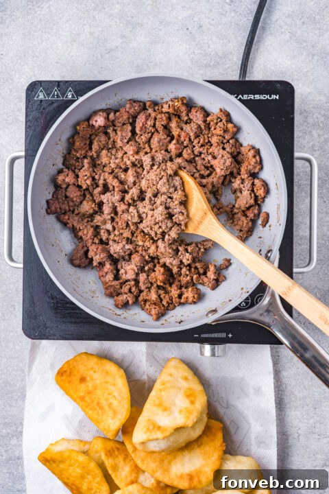 A hand grating cheese for the chalupa topping.