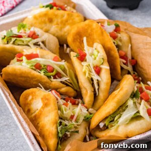 Finished Taco Bell Chalupas served on a plate with fresh ingredients.