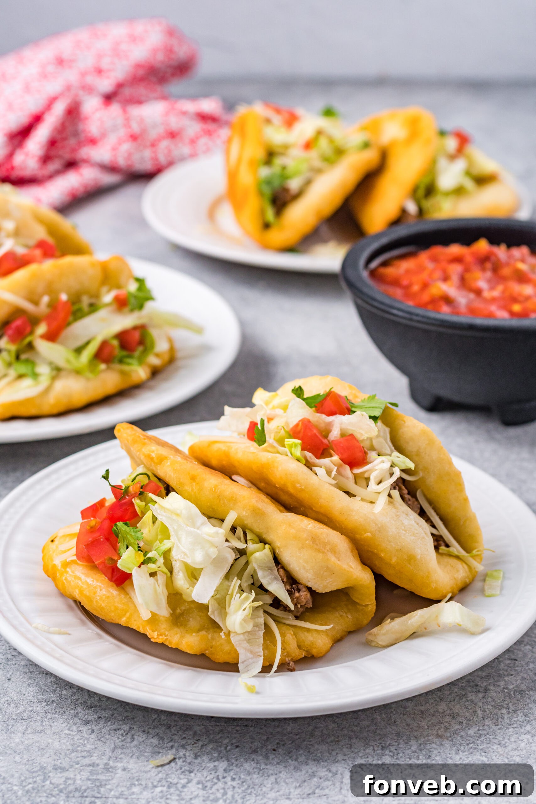 A front-facing view of two perfectly stuffed Taco Bell Chalupas on a white plate, ready to be picked up and enjoyed.