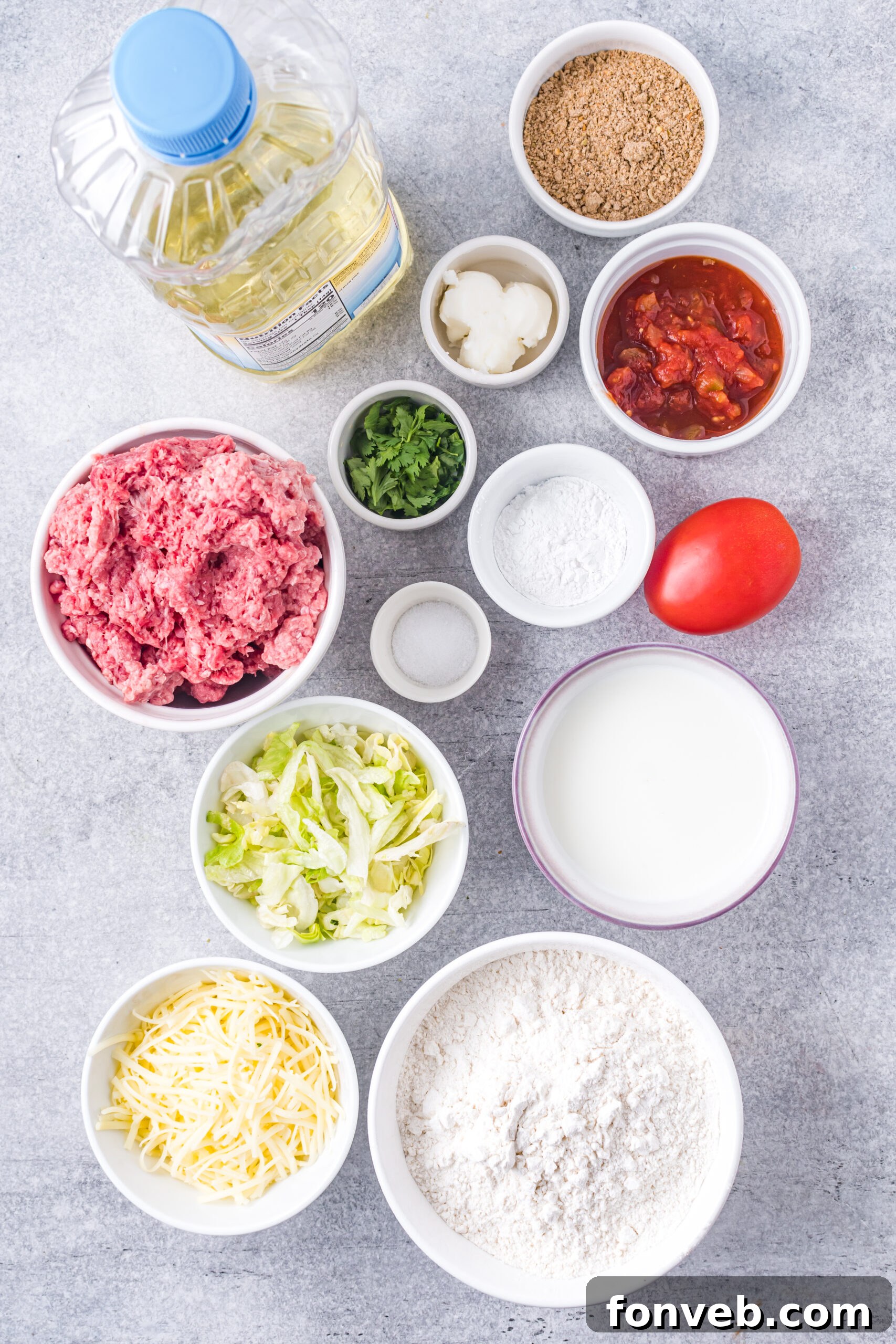 An overhead shot showcasing a curated selection of fresh ingredients required for the Taco Bell Chalupas recipe, neatly arranged in small bowls.
