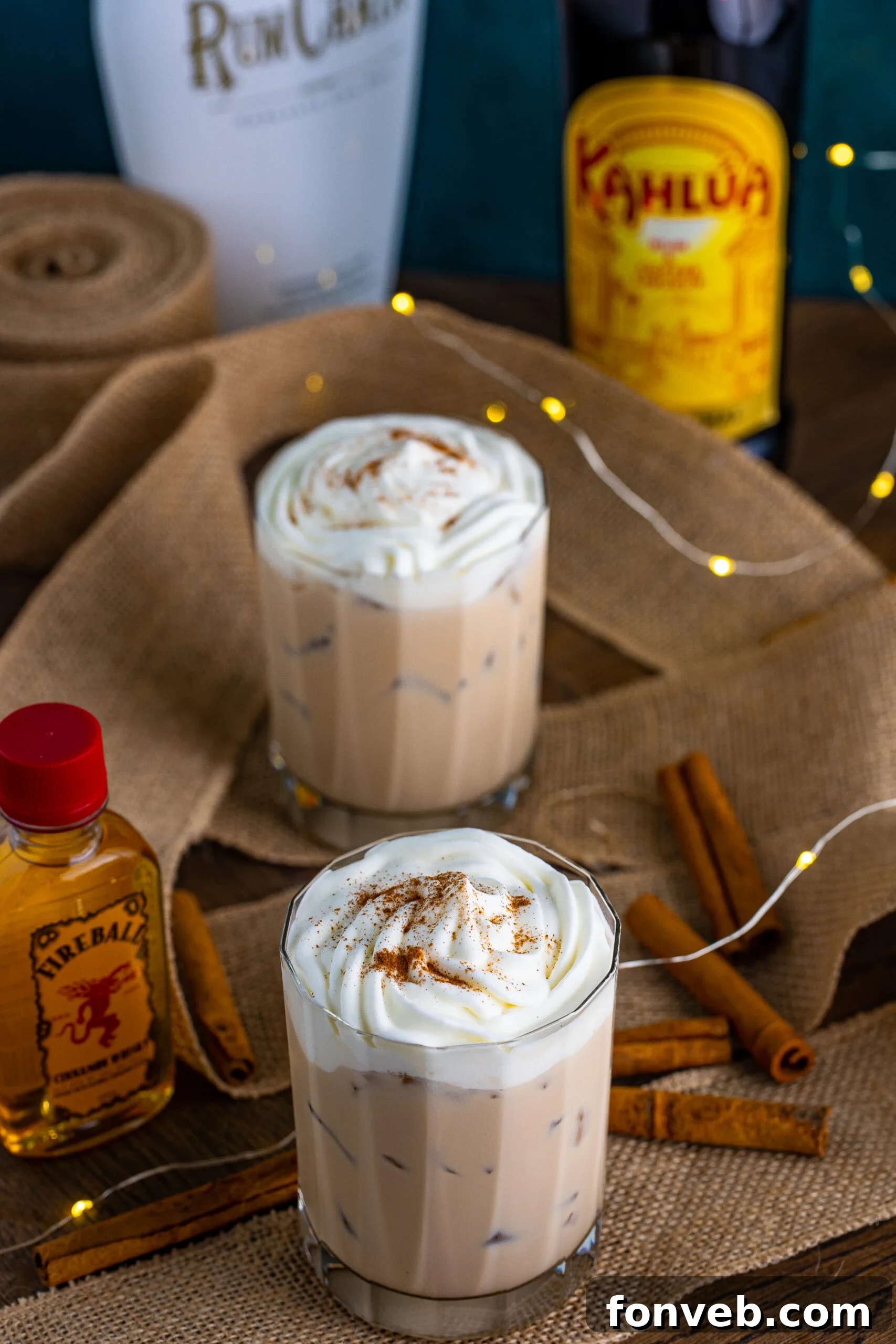 View of Cinnamon Roll Cocktail surrounded with cinnamon sticks.