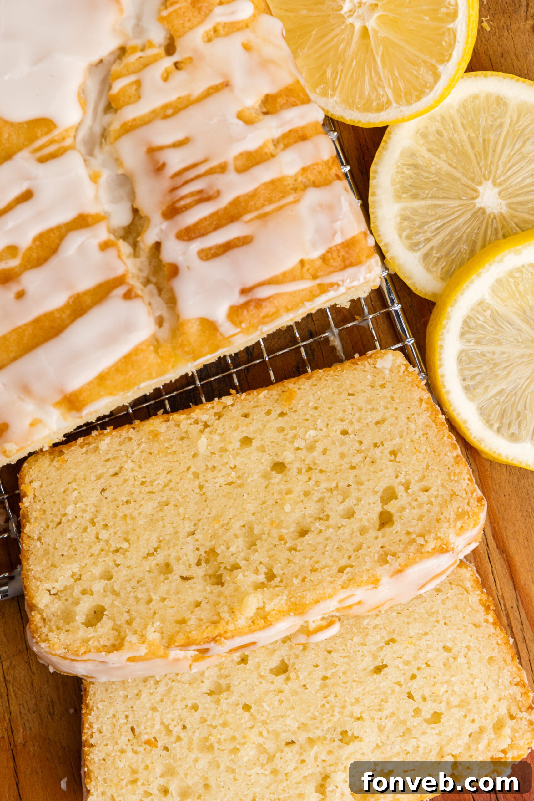 Overhead view of slices cut from a loaf of  Lemon Bread on a wire rack.