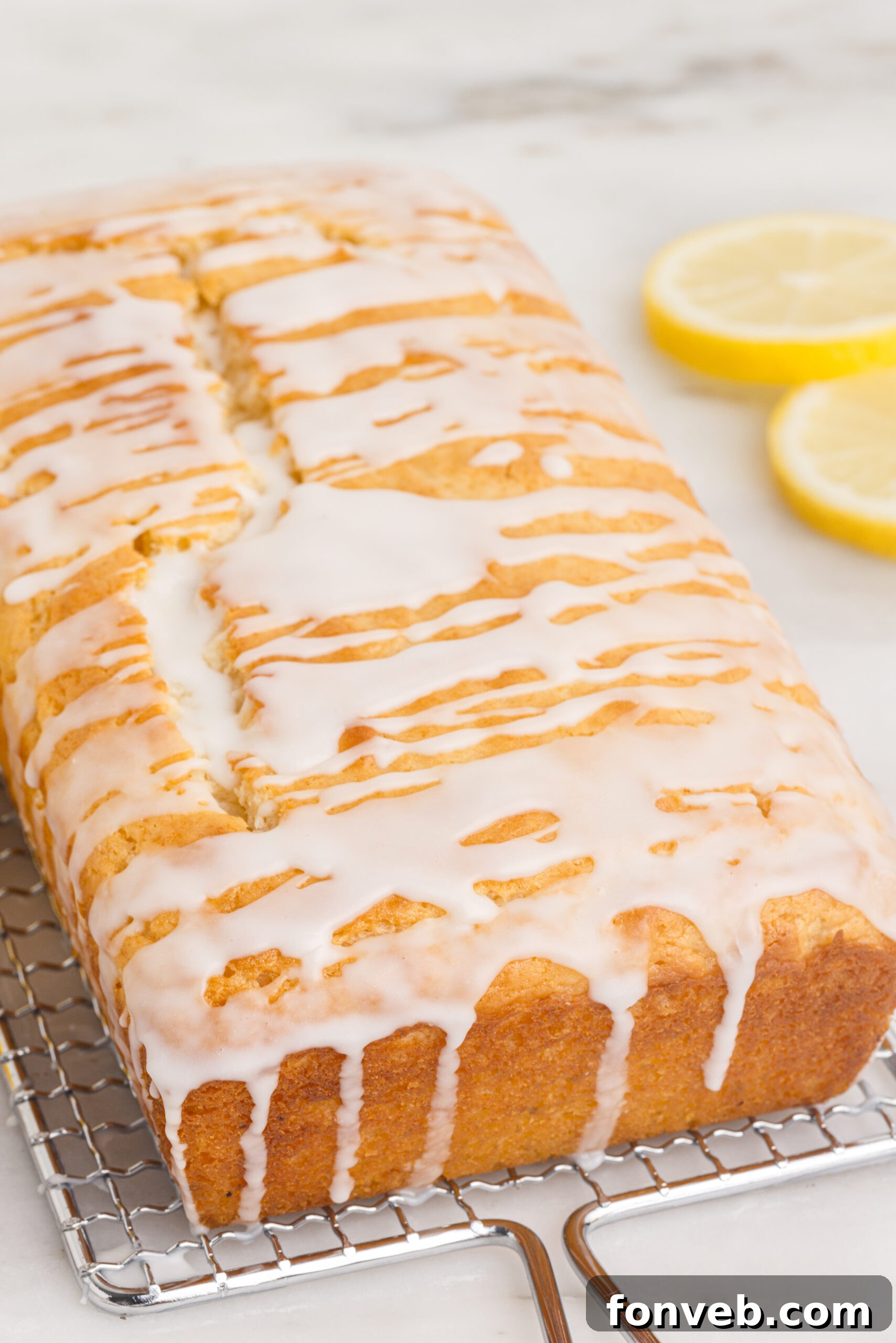 Front view of  Lemon Bread on a wire rack showing the close up of the glaze 