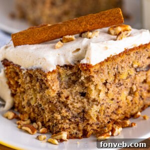 A delicious Hummingbird Cake slice on a white plate, ready to be enjoyed.