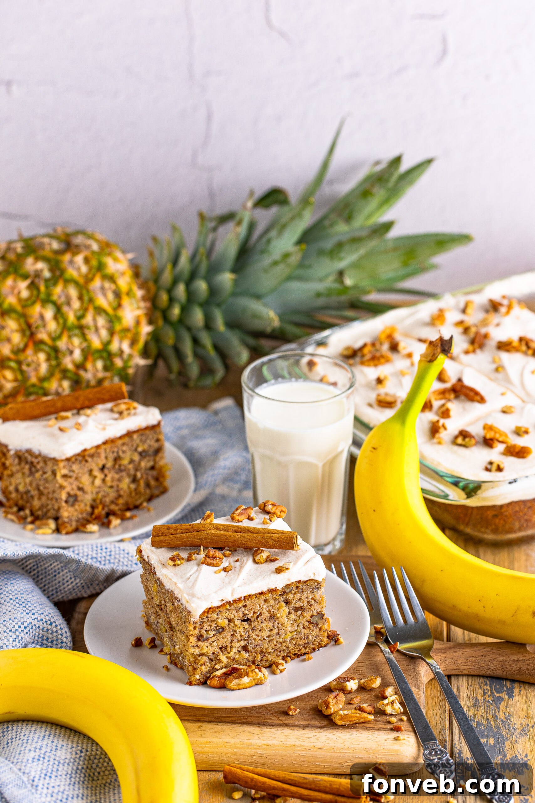 A close-up shot of a Hummingbird Cake, expertly frosted and decorated with pecans, ready to be served.