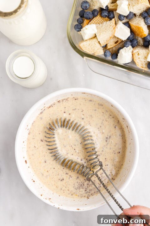 Bread cubes and cream cheese mixed together in a bowl.